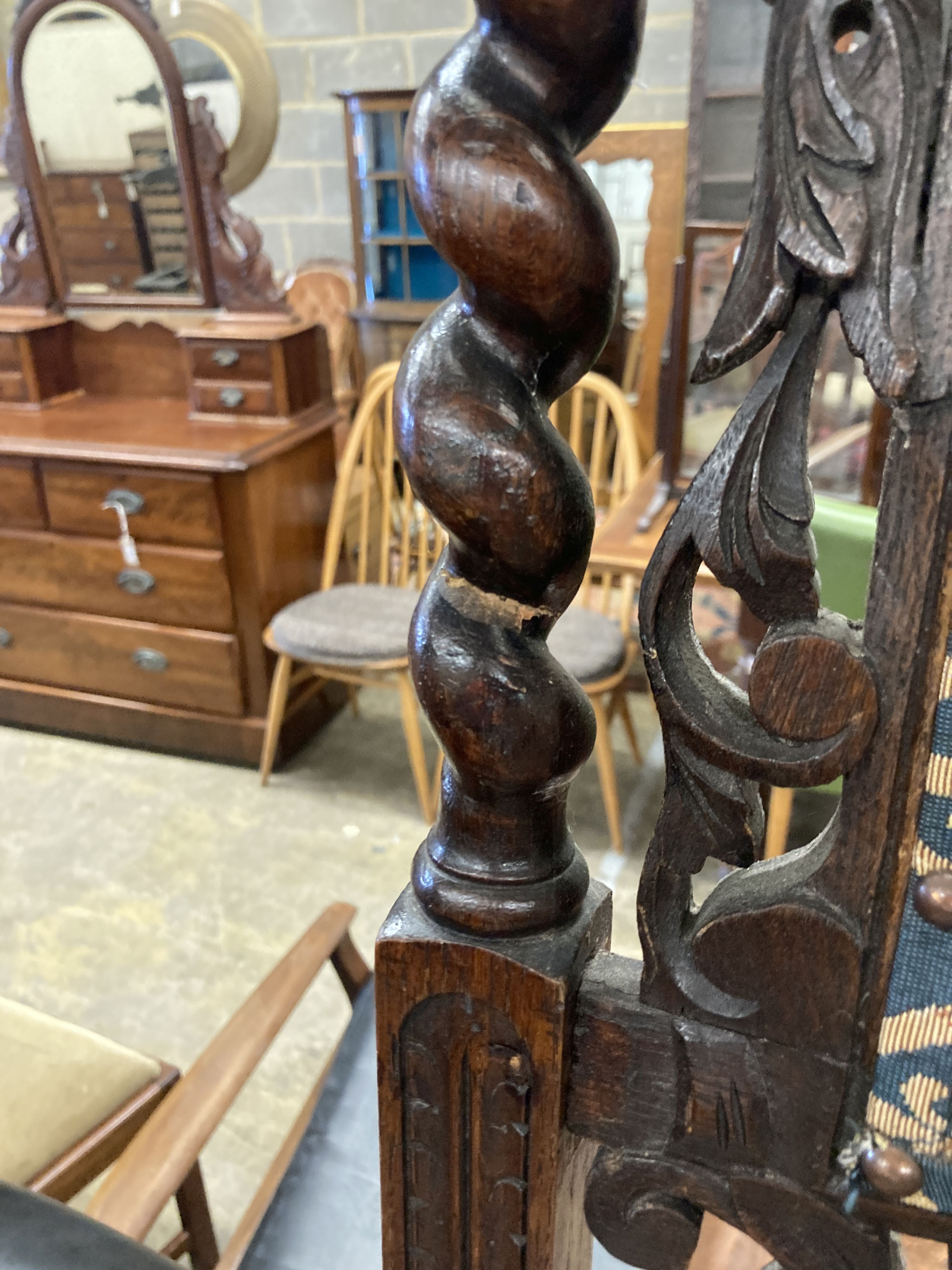 A pair of late 19th century Flemish carved oak panel backed dining chairs